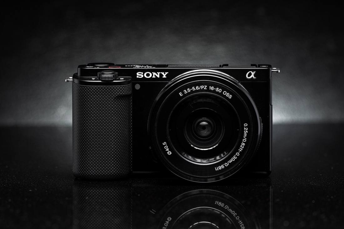 Sony ZV-E10 с китовым объективом 16–50 мм на тёмном фоне